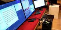 computer monitors sitting on church pew