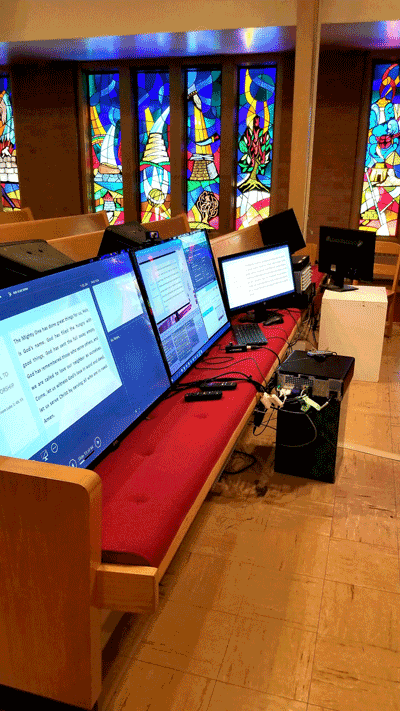 computer monitors sitting on church pew